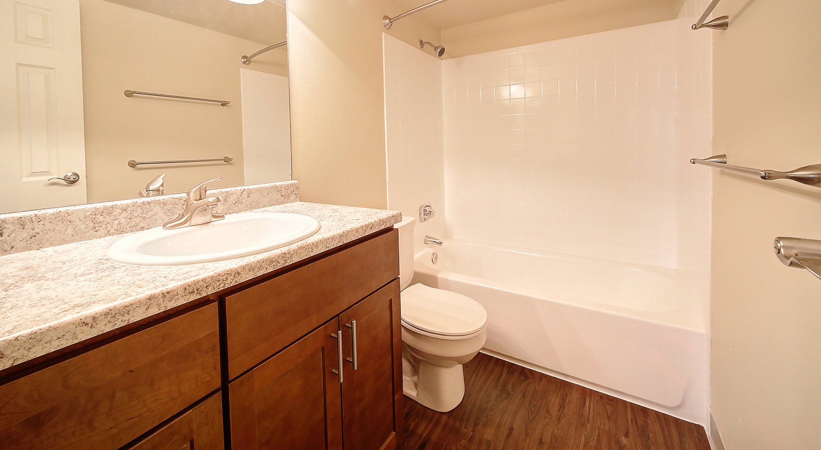 Bath Bath with single vanity and large mirror with plenty of light.