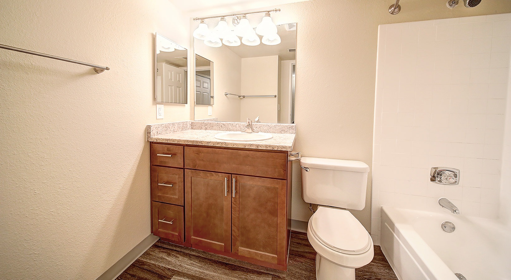 Bath Bath with single vanity and large mirror with plenty of light.